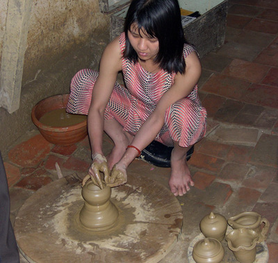 Woman Demonstrating
  Pottery-Making, Hoi An › February 2005.